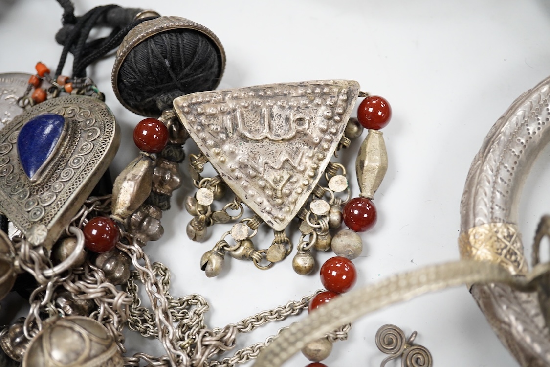 A collection of Bedouin white metal, gilt metal, lapis lazuli mounted jewellery, etc. from Oman